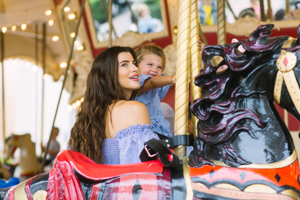 Mom and daughter on the Carousel at Irvine Spectrum Center